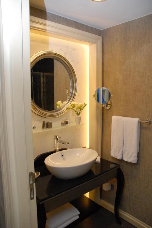 a bathroom with a sink and a mirror at Limak Eurasia Luxury Hotel in Istanbul