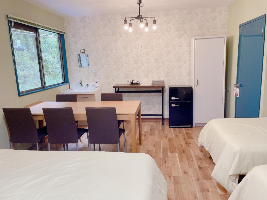 a room with a table and a kitchen with two beds at Cate no mori - Vacation STAY 52818v in Shime