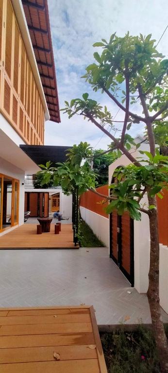 a courtyard with two trees in a building at 41 Village Mai in Phan Thiet