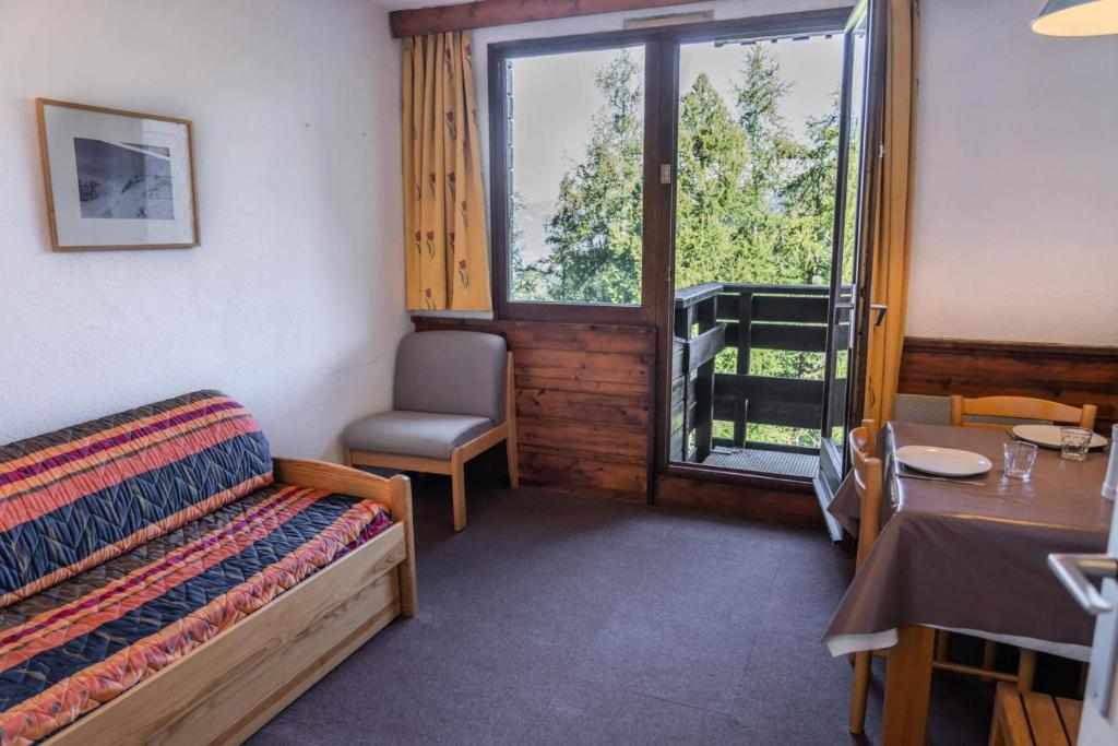 une chambre avec un lit, une table et une fenêtre dans l'établissement Résidence Le Belvedere - Studio au coeur des Orres 1650 MAE-6944, aux Orres