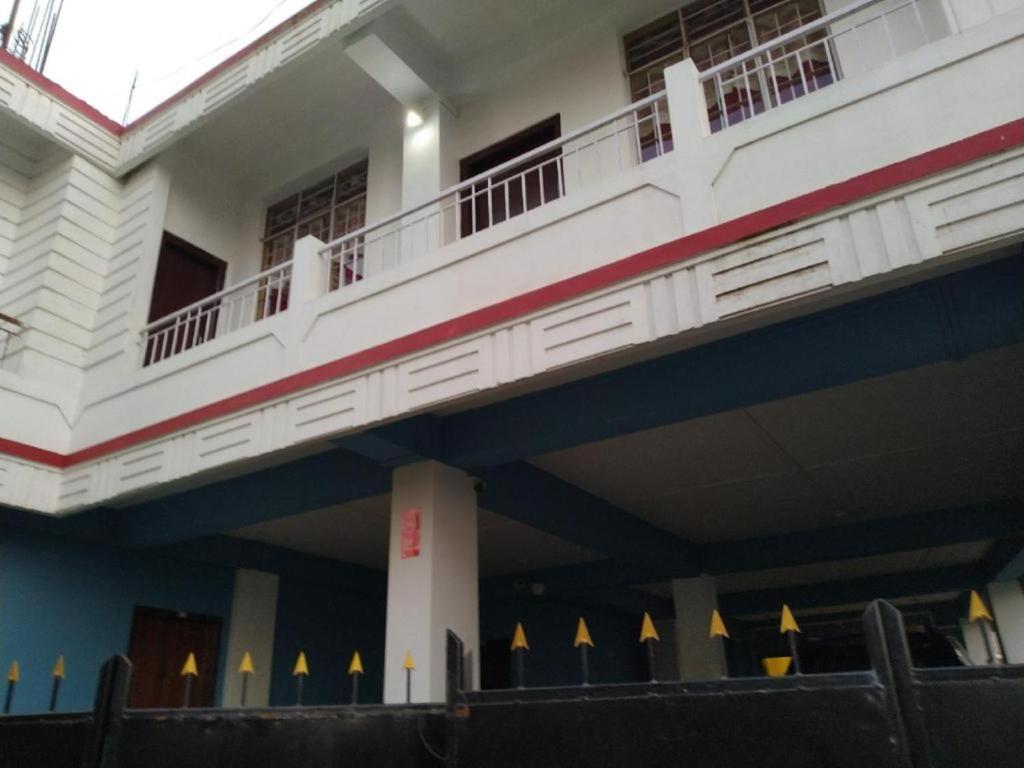 a building with a balcony on top of it at Stay Inn Pumpkin Guest House in Shillong