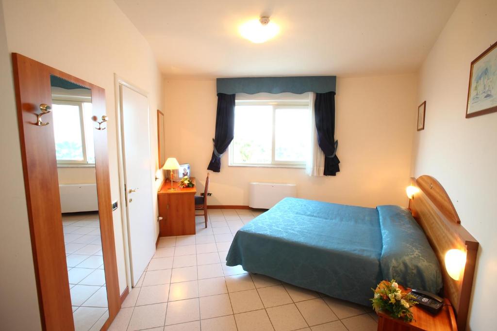 Postel nebo postele na pokoji v ubytování Partenone Resort Hotel