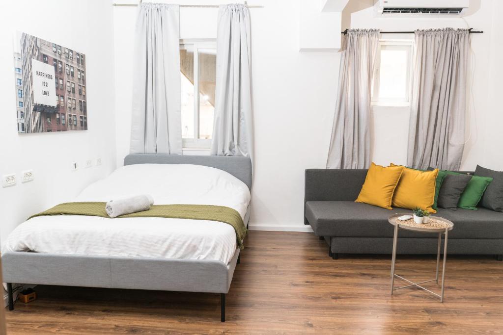 a bedroom with a bed and a couch at kotel apartment in Jerusalem