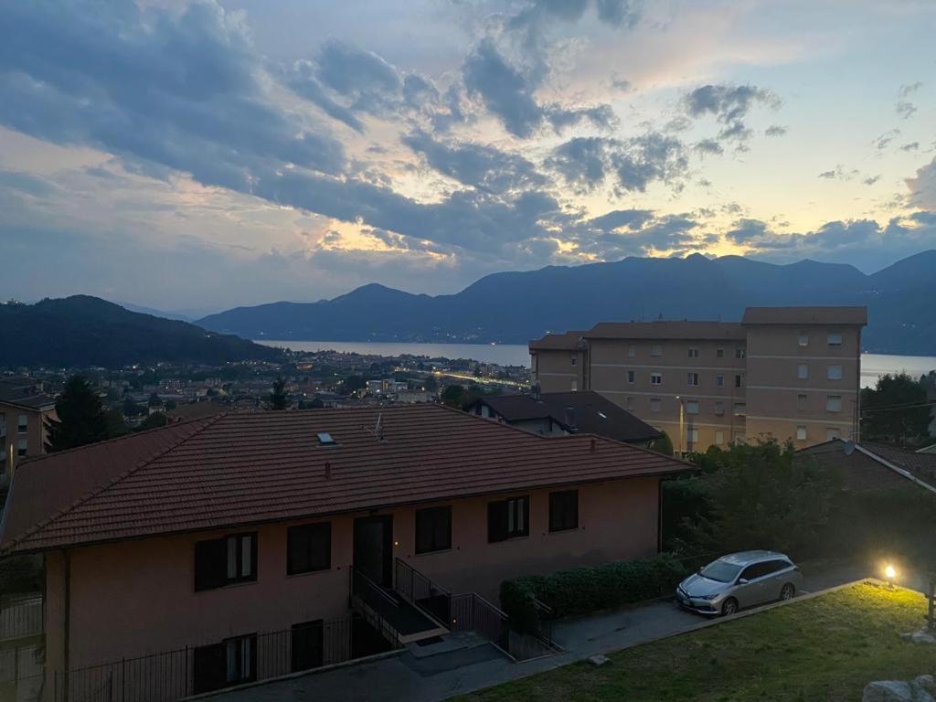 a car parked in front of a house with a sunset at Hygge Holiday House in Luino