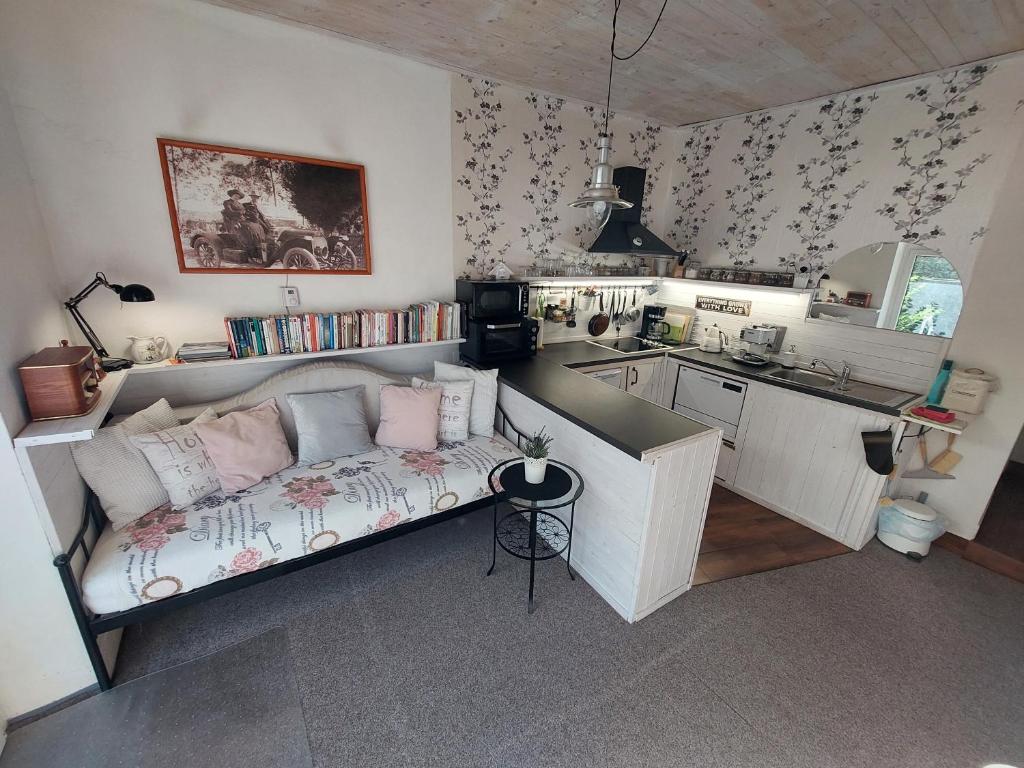 a living room with a couch and a kitchen at Apartmán Aromasalon in Třebíč