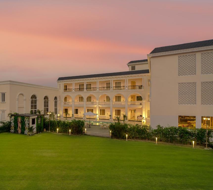 a building with a lawn in front of it at Rudra Imperial Resort in Sītāpur