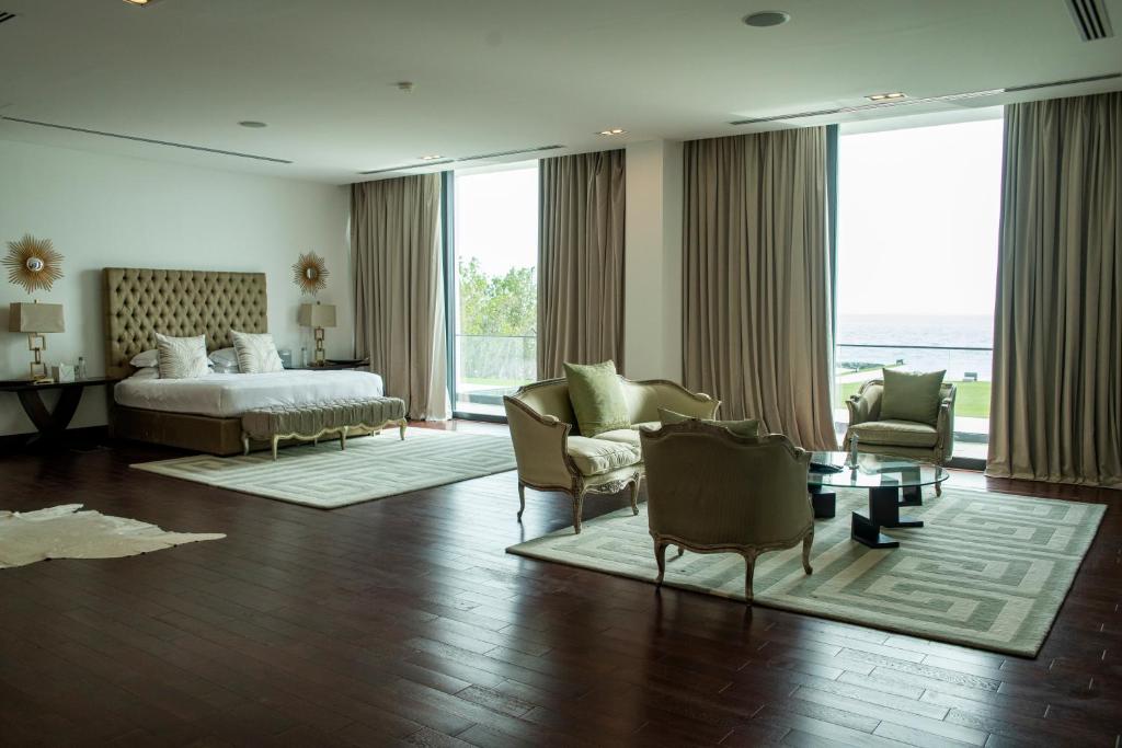 um quarto de hotel com uma cama e uma cama e cadeiras em Nurai Losin em Abu Dhabi