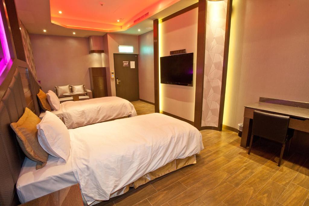 Postel nebo postele na pokoji v ubytování Wei Feng Hotel - Kaohsiung