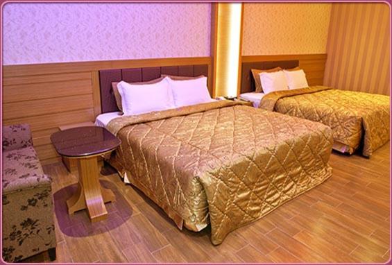 Postel nebo postele na pokoji v ubytování Wei Feng Hotel - Kaohsiung
