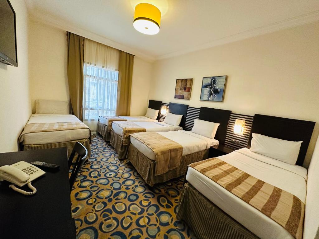 Postel nebo postele na pokoji v ubytování Saif Al Majd Hotel