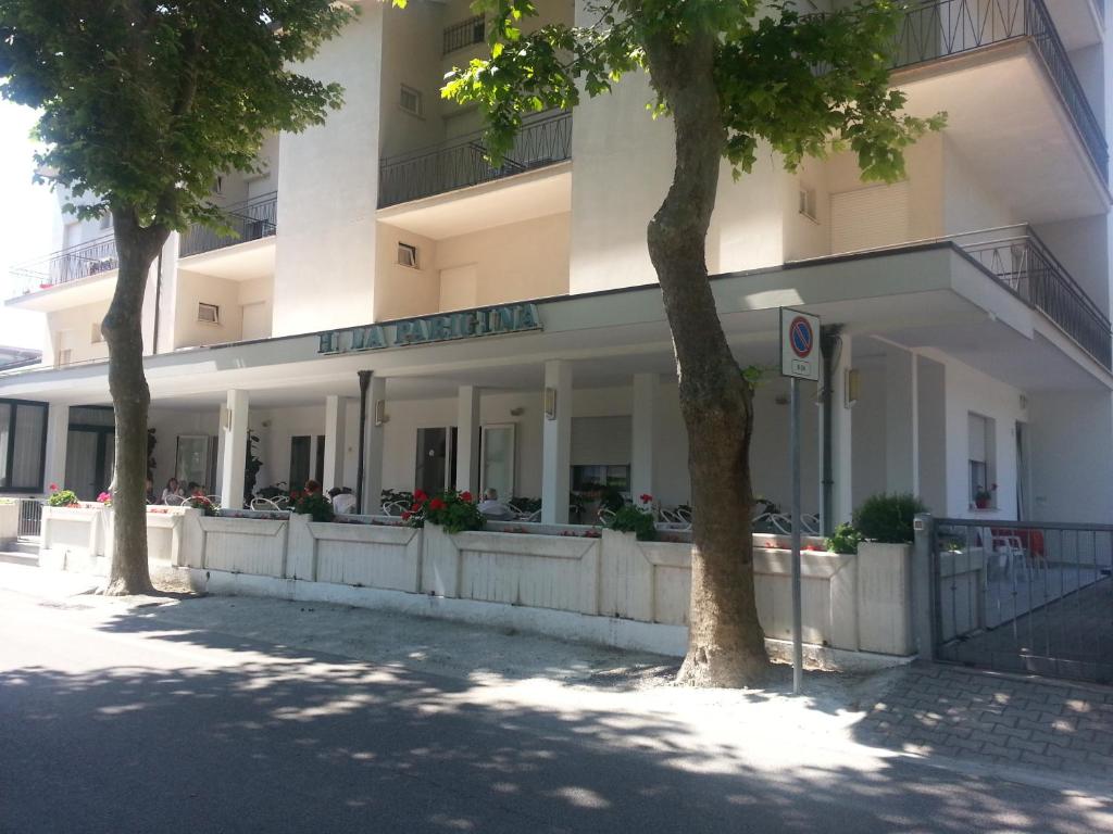 a building with two trees in front of it at Hotel La Parigina in Cesenatico