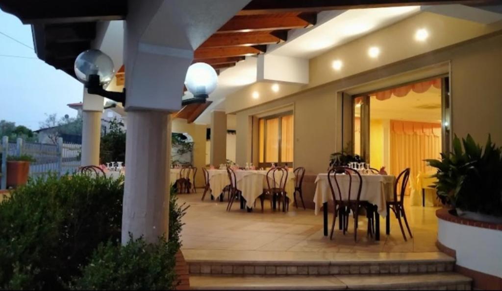 un restaurante con mesas y sillas en un patio en B&B Belvedere, en Zungri