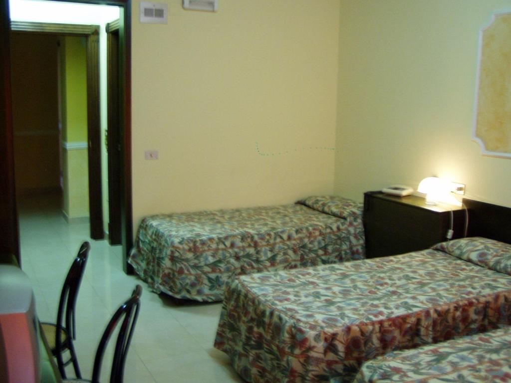 Postel nebo postele na pokoji v ubytování Hotel Le Dune