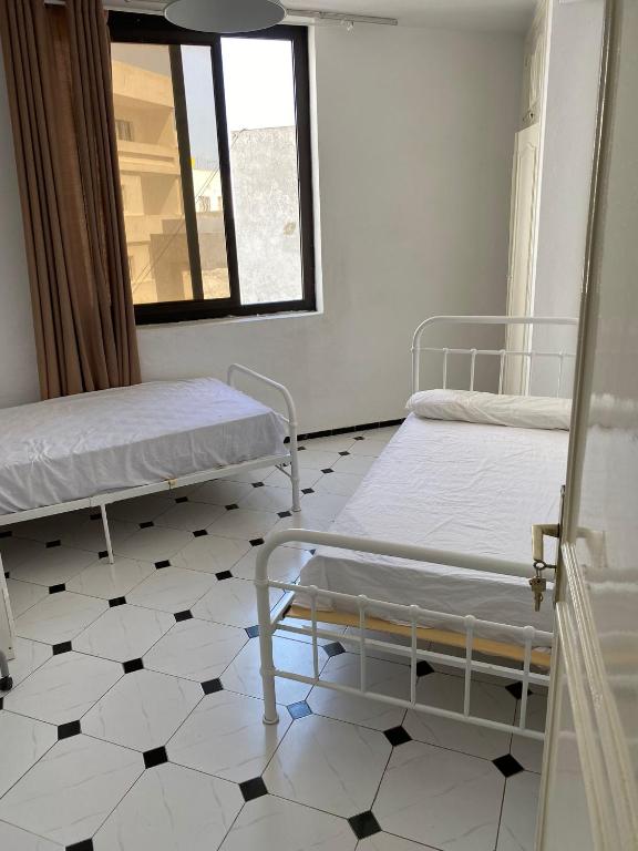 Postel nebo postele na pokoji v ubytování Tangier City center, room with 2 single beds
