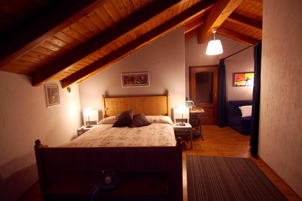 a bedroom with a large bed in a room at Relais Des Elfes in Châtillon