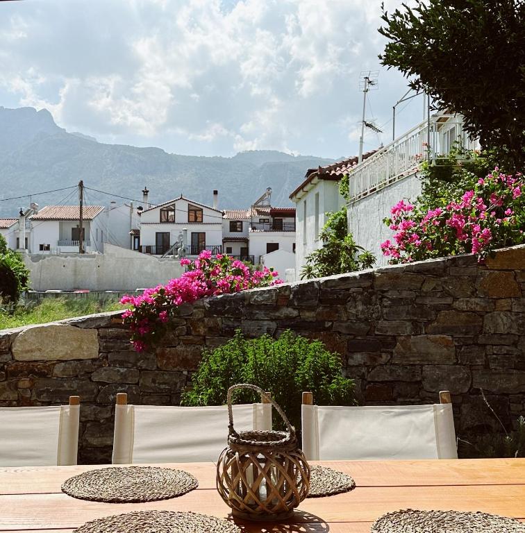 a table with chairs and a basket on top of it at Keepos by Polykratis in Kokkari