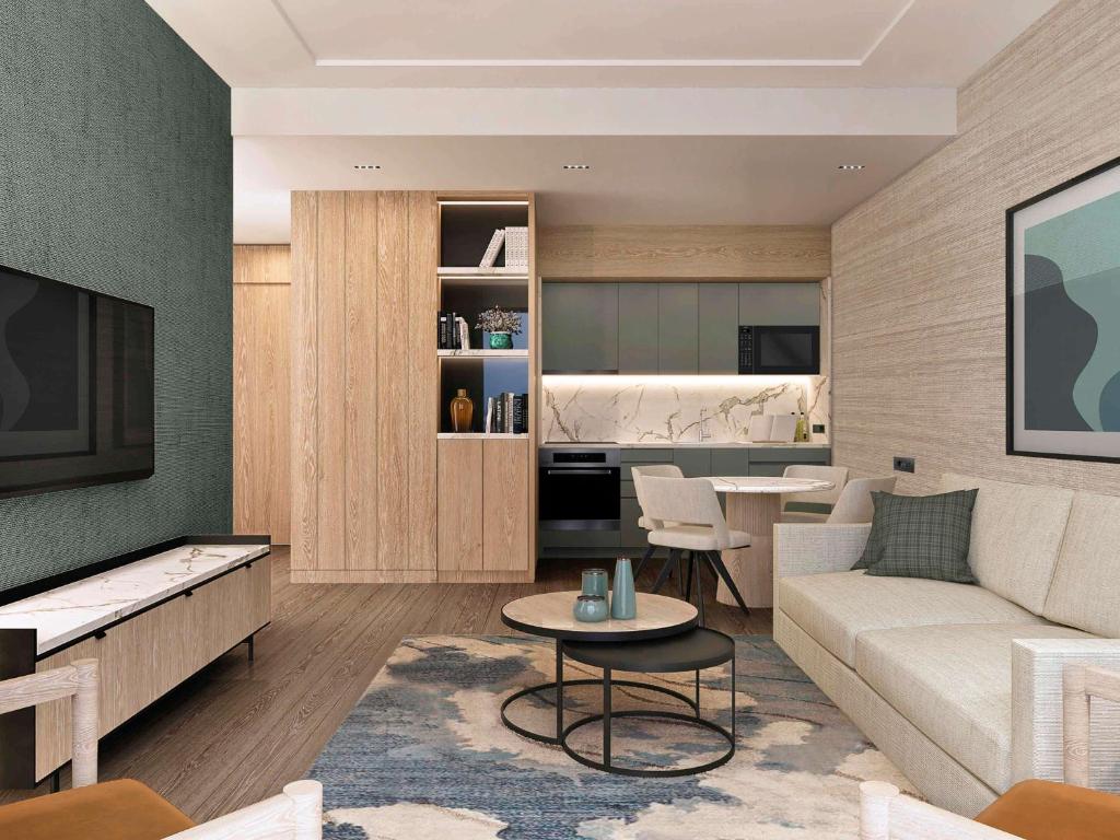 a living room with a couch and a table at Movenpick Living Istanbul Camlivadi in Istanbul