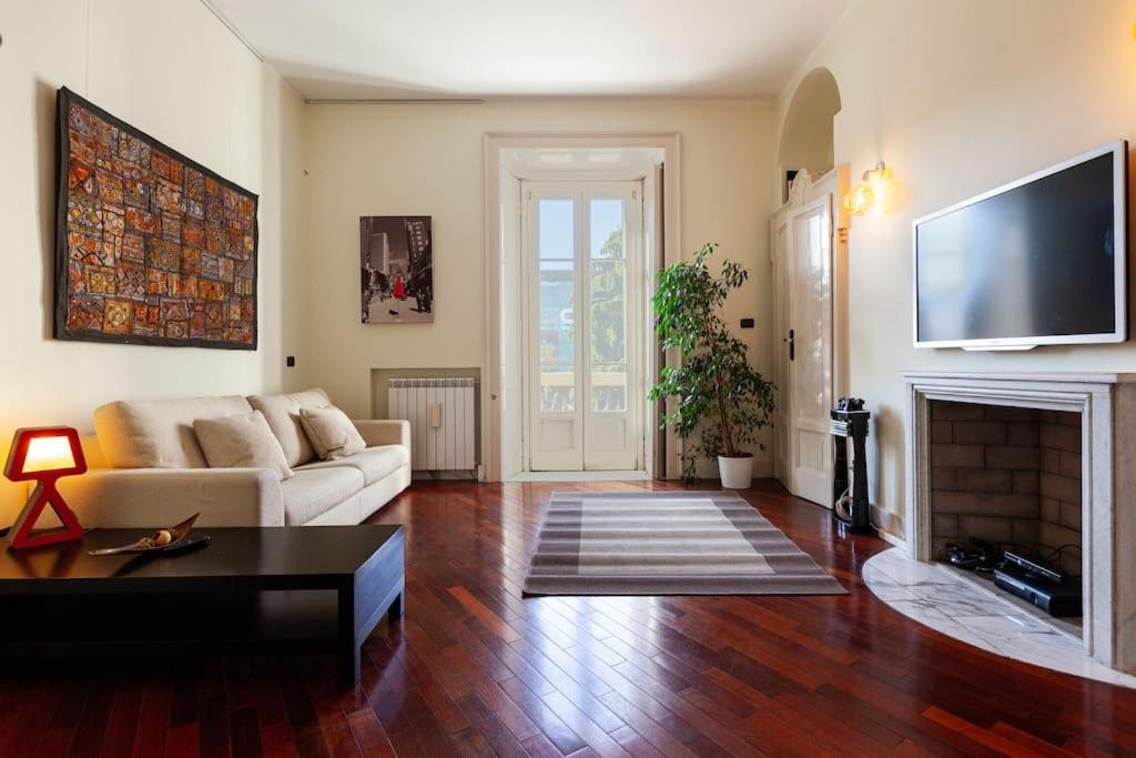 a living room with a couch and a fireplace at Casa Delle 5 Giornate di Milano in Milan