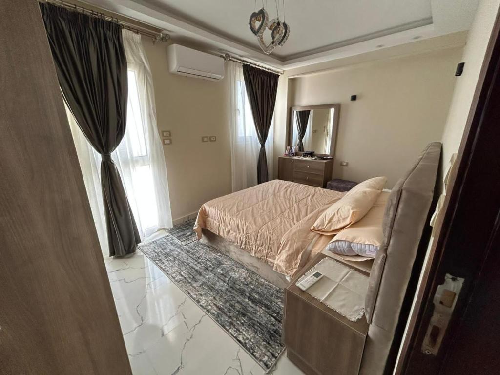 a bedroom with a bed and a mirror at Apartment Hossam 1 in Hurghada