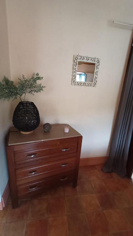 Cette chambre comprend une commode et un miroir mural. dans l'établissement Gîte La Source de Label, à Saint-Paul-des-Fonts