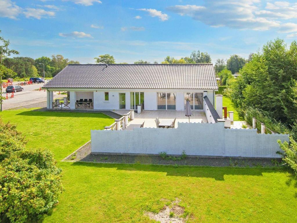 an overhead view of a white house with a yard at 10 person holiday home in Grenaa in Grenå