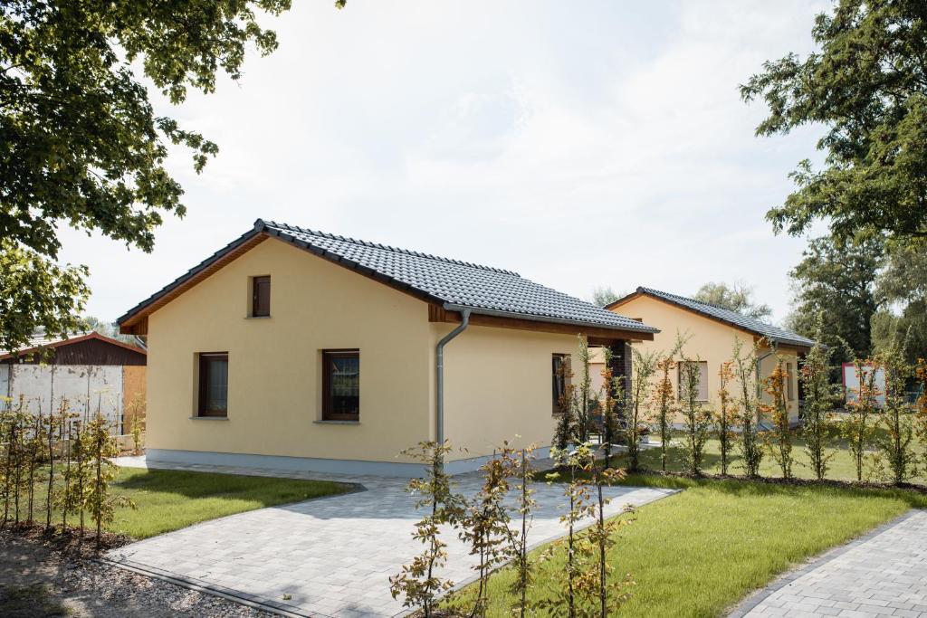 a house with a black roof at Havelstern Ketzin, Ferienhaus Barsch in Ketzin