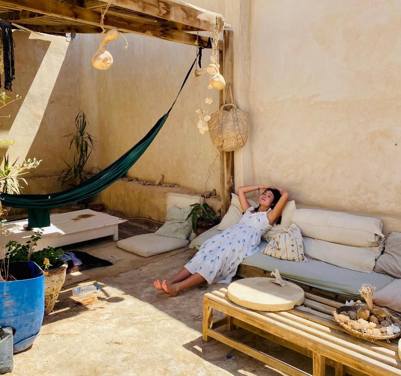 a woman laying on a couch in a living room at Baben Home in Siwa