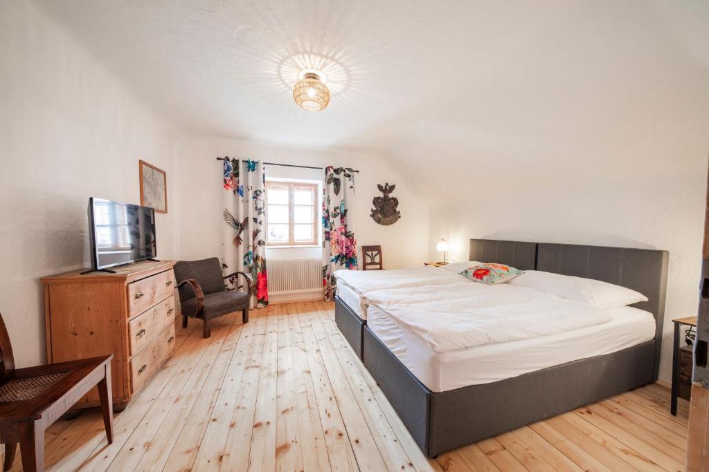 a bedroom with a large bed and a television at Ferienwohnung Alter Brotladen in Melk