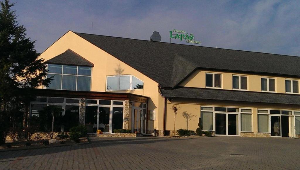 a building with a sign on the top of it at Penzion Lapáš u Hoffera in Nitra