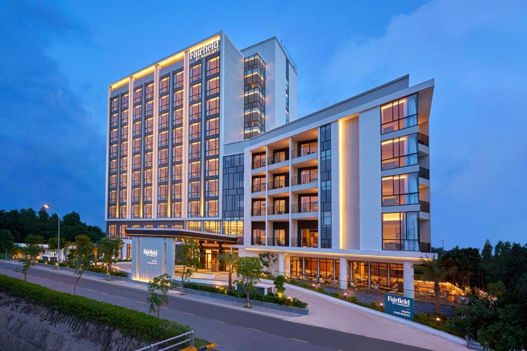 a rendering of a hotel building at dusk at Fairfield by Marriott South Binh Duong in Thuan An