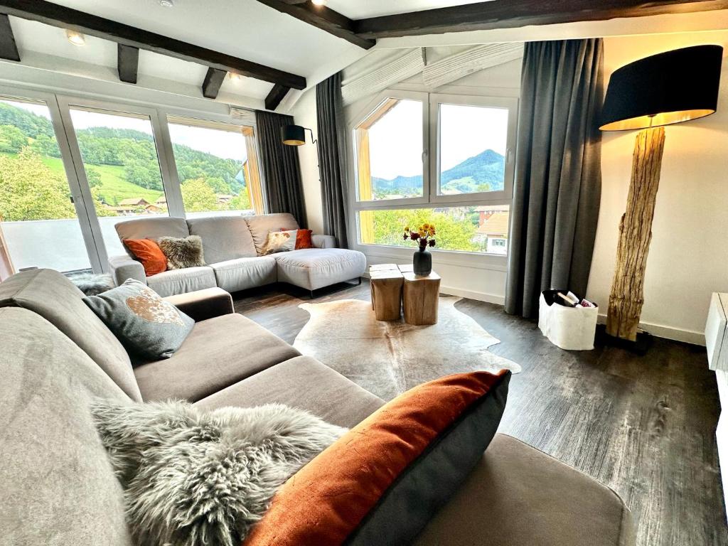 a living room with a couch and a table at AlpenOase - Schliersee in Schliersee