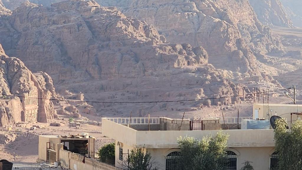 a building in front of a mountain in the desert at Window on petra in Wadi Musa