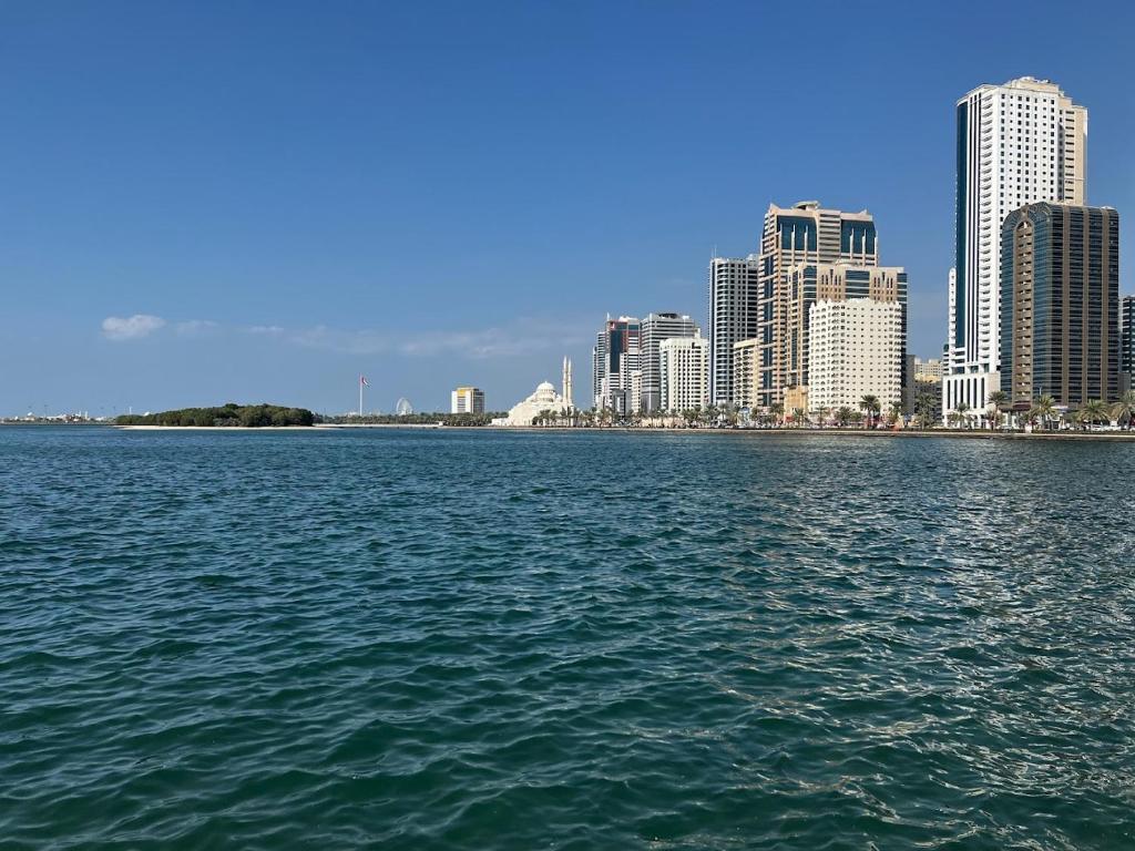 a large body of water in front of a city at Holiday Home 2 Bedrooms Apartment for Family Only in Sharjah