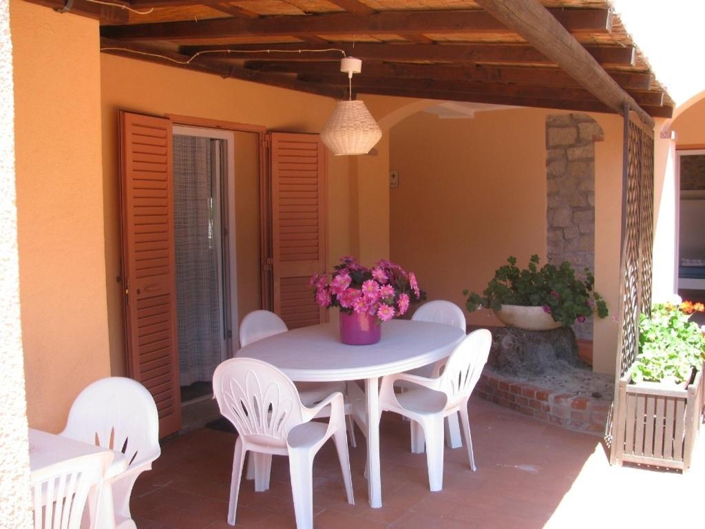 a white table and chairs on a patio at Onda Su Onda Appartamenti in Seccheto