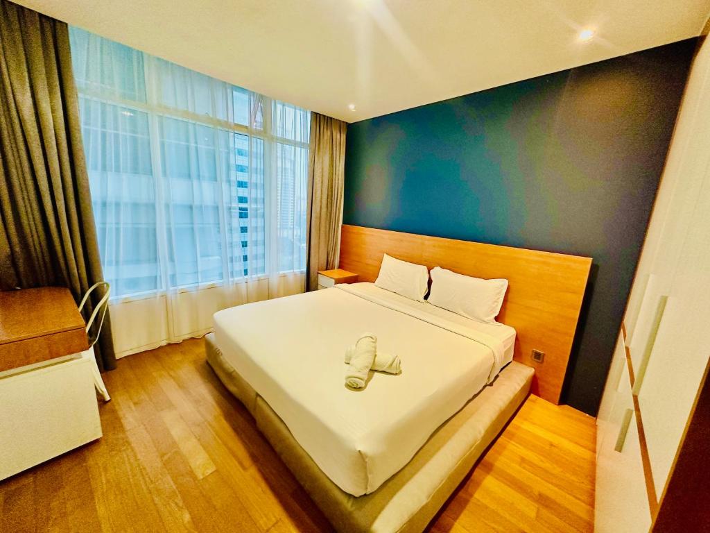 um quarto com uma cama e uma grande janela em Vortex Suites KLCC by UNIQUE em Kuala Lumpur