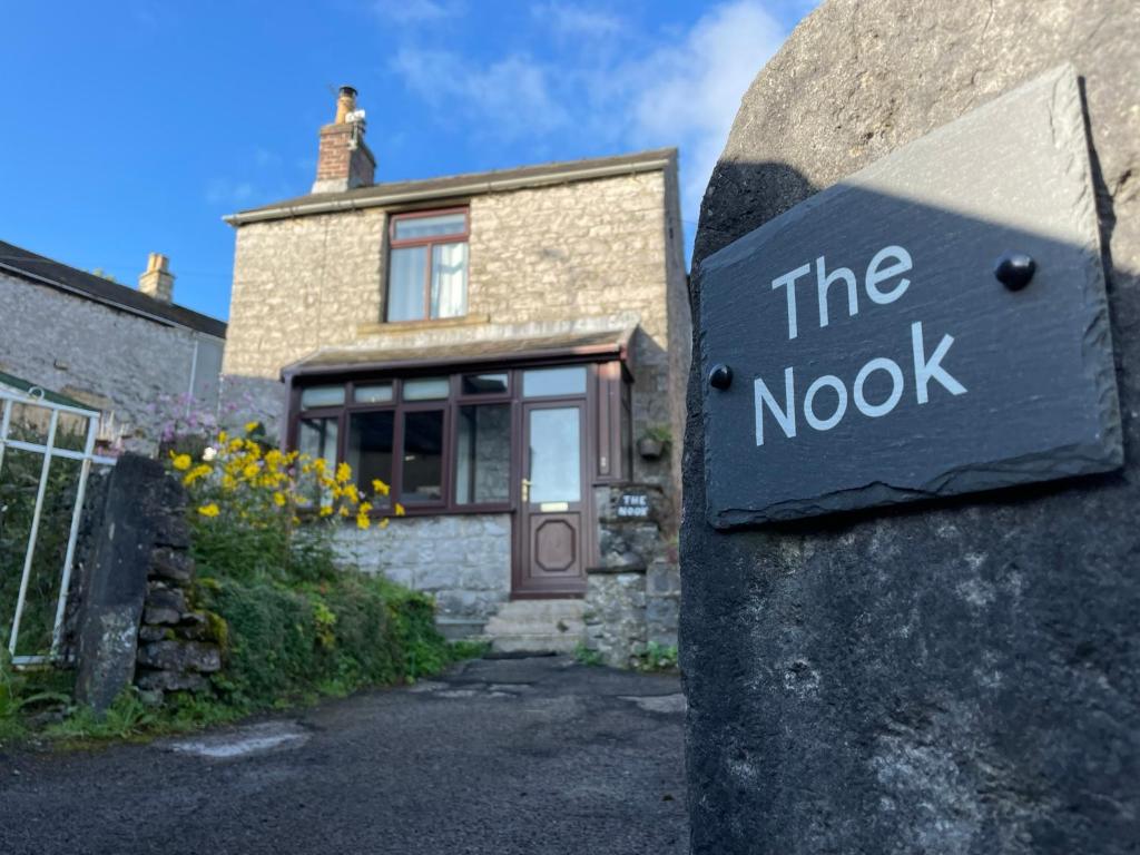 a sign that reads the node in front of a house at Muddy Paws Cottages - The Nook in Taddington