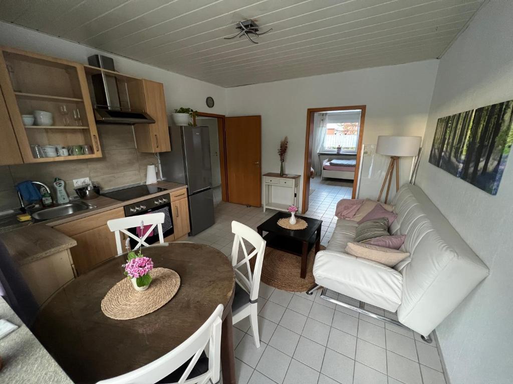 a kitchen and a living room with a table and a couch at Auszeit im Pott - Ferienwohnung Lavendel in Herten