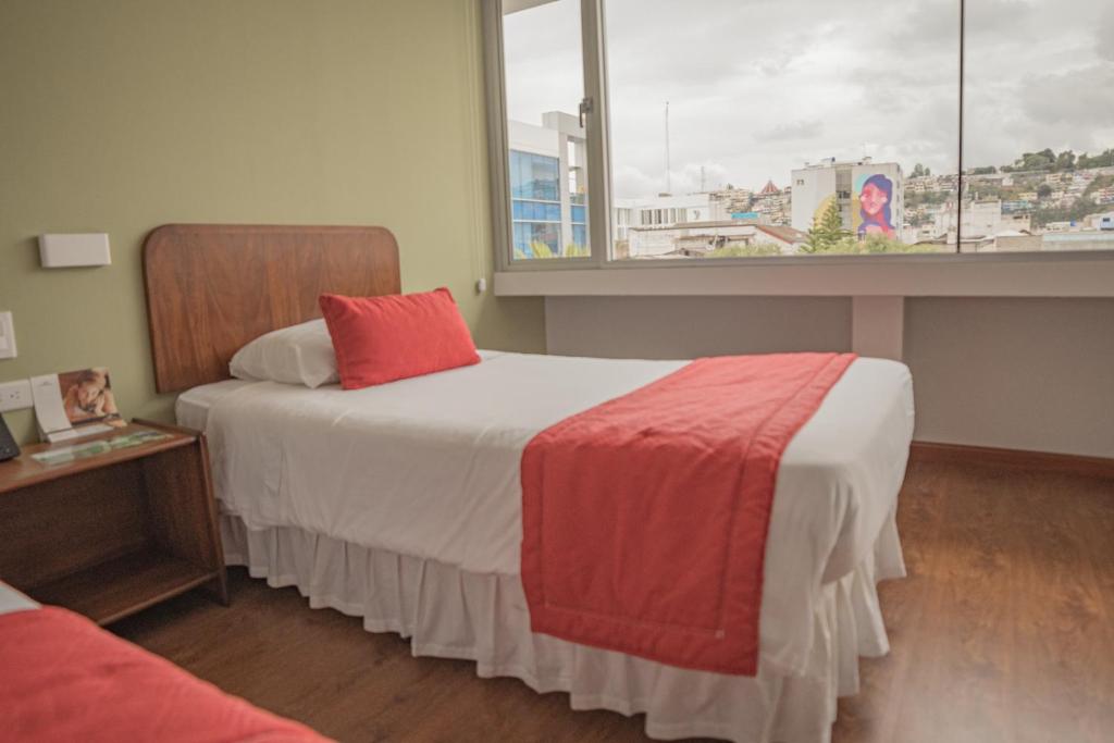 Postel nebo postele na pokoji v ubytování Hotel Ambato