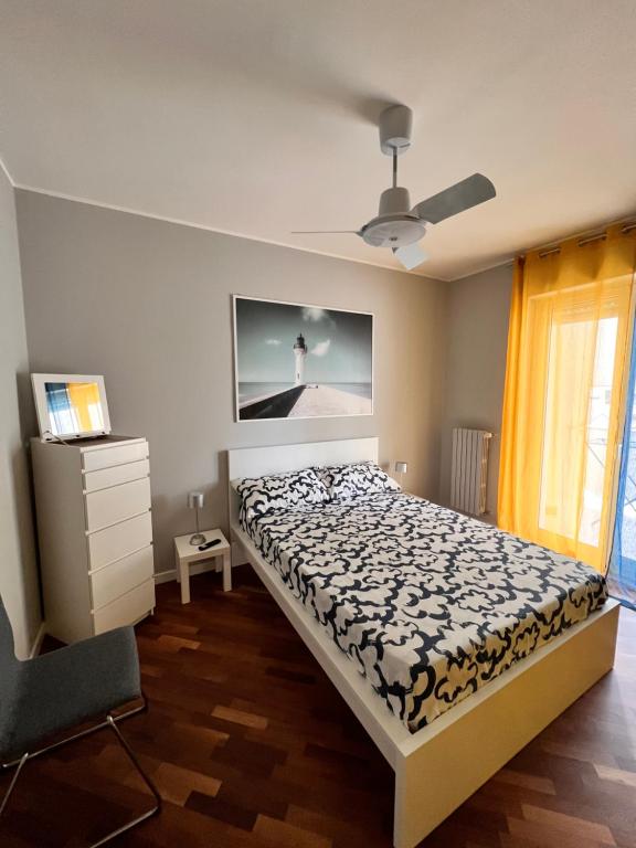 a bedroom with a bed and a tv on the wall at Faro Sul Mare Luxury Apartment - Zona Fiera in Bari