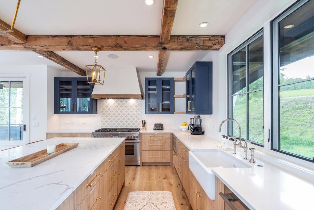 a kitchen with wooden cabinets and a large window at Overlook House home in Telluride