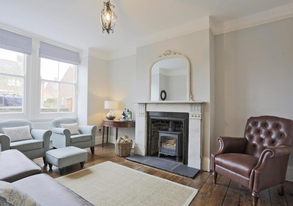 a living room with a couch and a fireplace at Bay House in Southwold