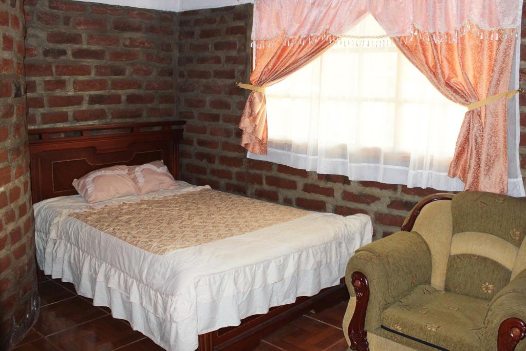 Postel nebo postele na pokoji v ubytování Rumipaxi Lodge