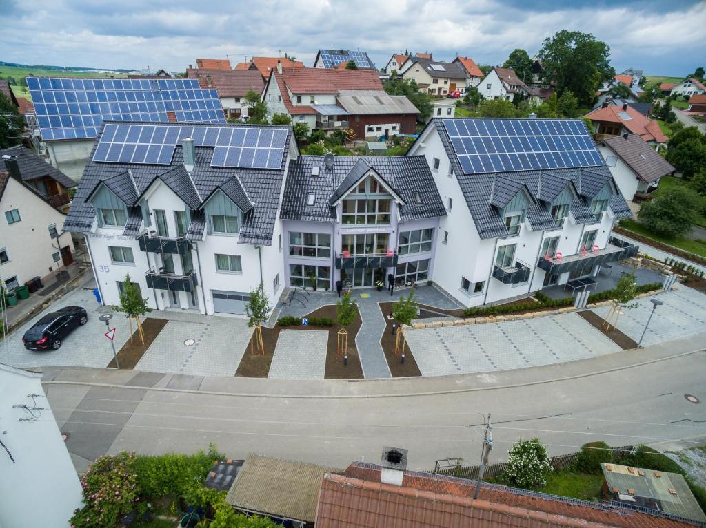an image of a house with solar panels on it at Leidringer Gästehaus in Rosenfeld