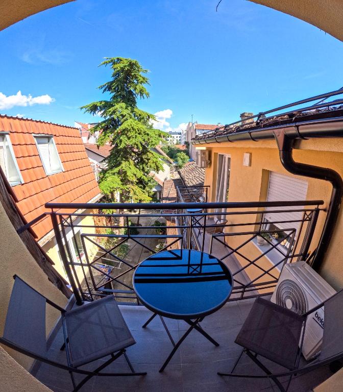 a view of a balcony with chairs and a swing at SND Aparts in Novi Sad
