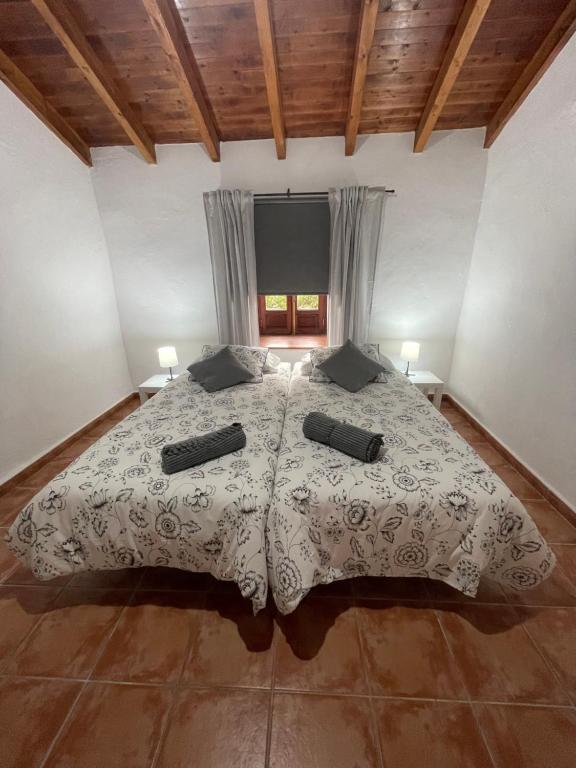 a bedroom with a bed with two pillows on it at Vv Casa Muya in Icod de los Vinos