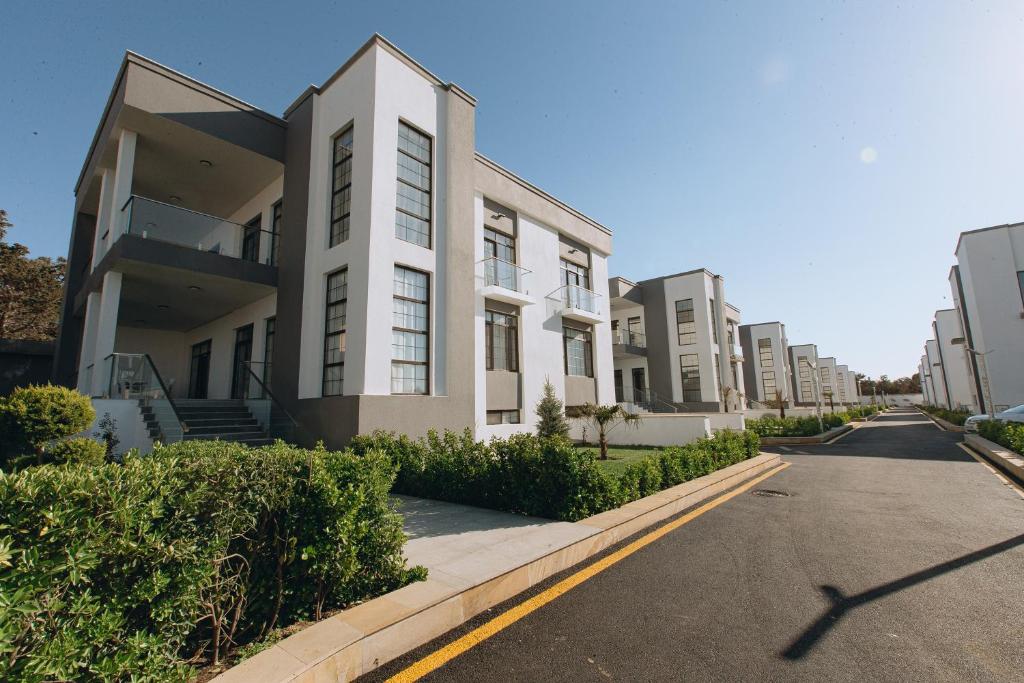 a row of apartment buildings on a street at Buzovna Villas in Buzovna