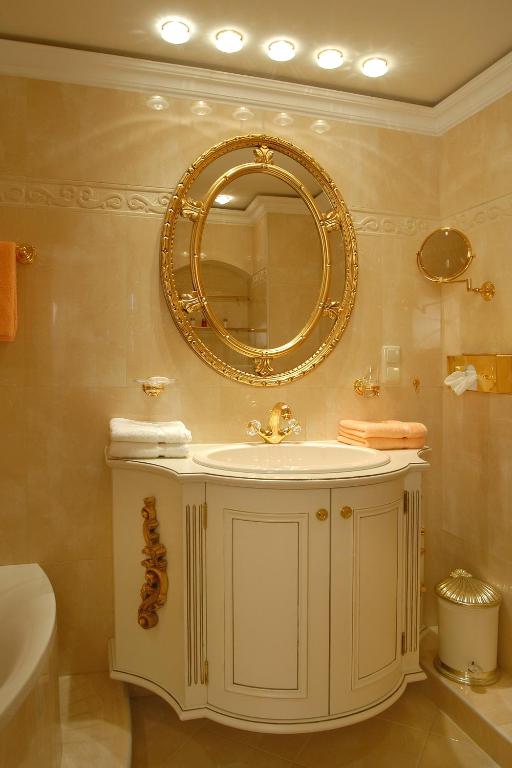 a bathroom with a sink and a mirror on the wall at Hotel Schloss Dürnstein in Dürnstein
