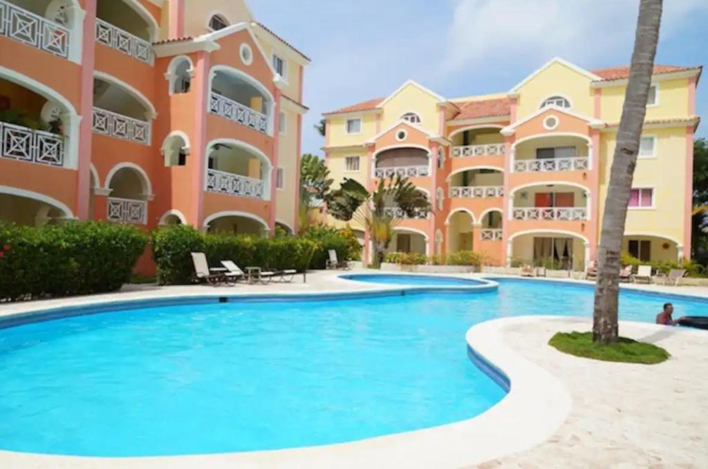 a large swimming pool in front of a building at El Dorado Condo 208A in Punta Cana
