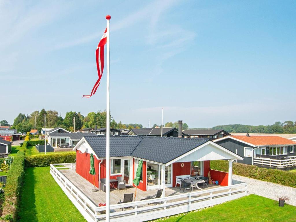 a house with a flag in front of it at 6 person holiday home in Juelsminde in Sønderby