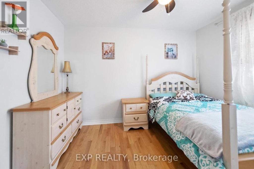 a bedroom with a bed and a dresser and a mirror at Cozy Place-Laid Back in Mississauga